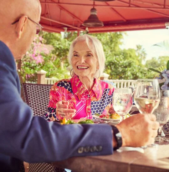 A senior woman smiling at a senior man