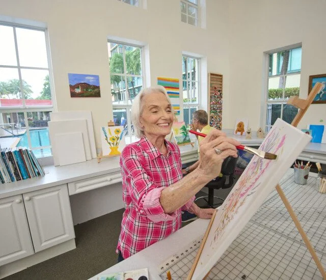Senior women painting on a canvas