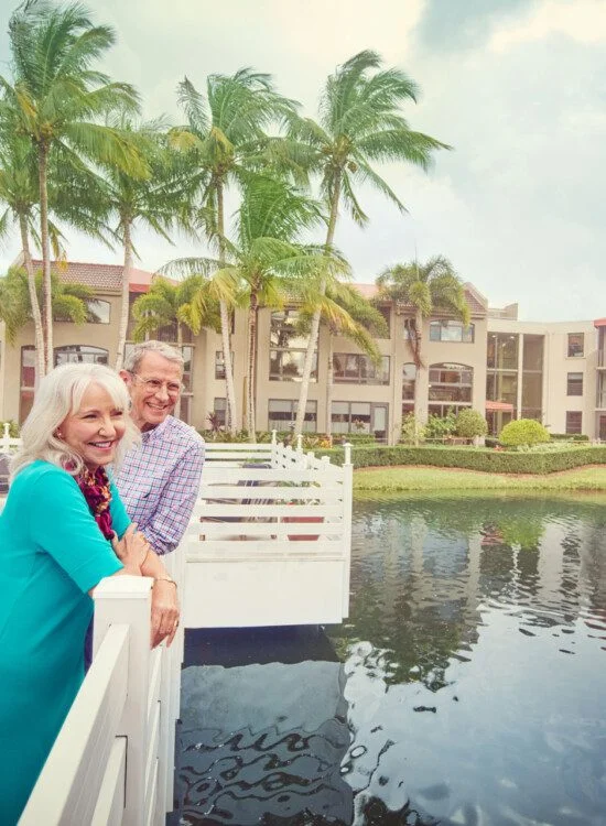 A senior couple overlooking the water on a bridge