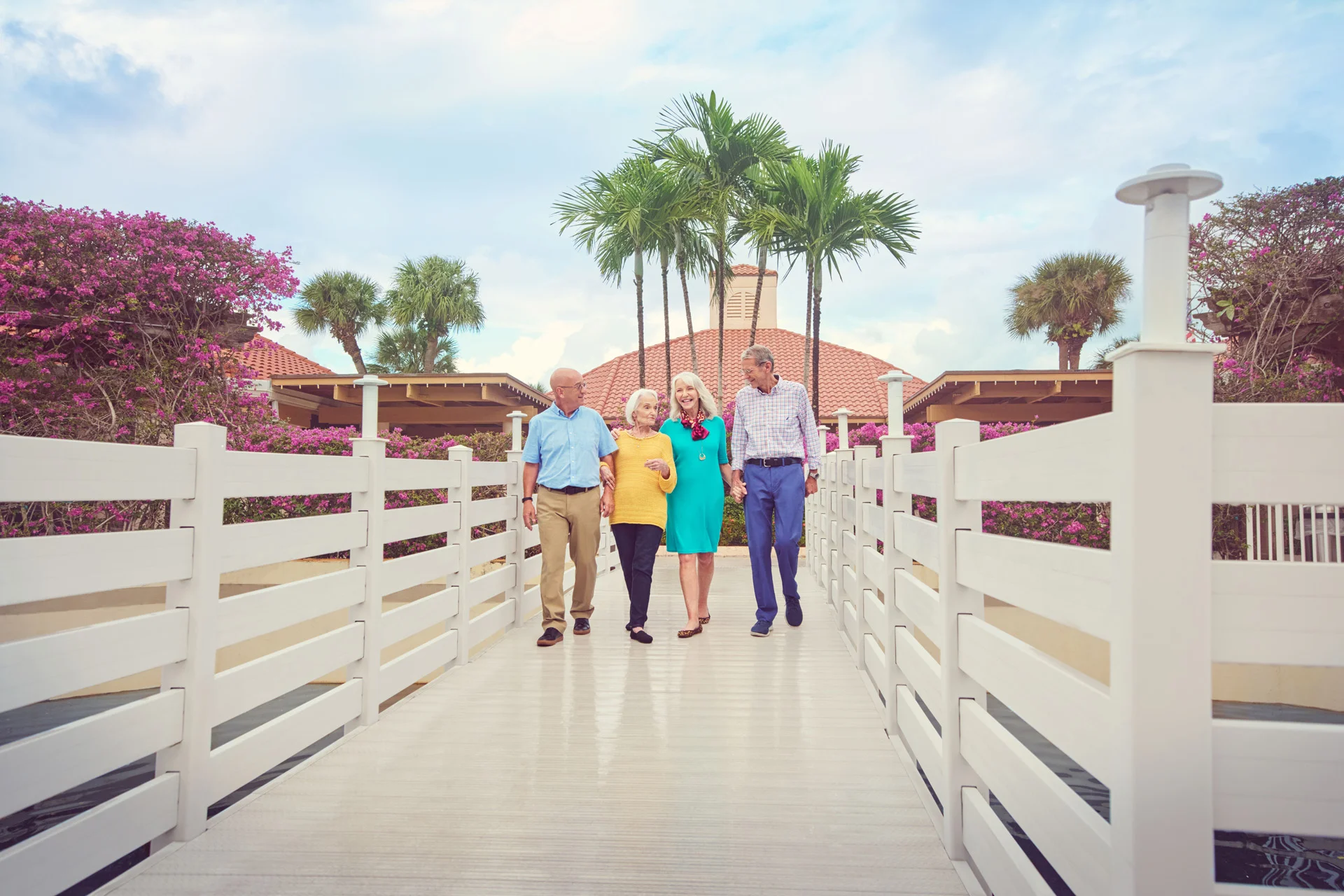A group of seniors walking down a bridge together