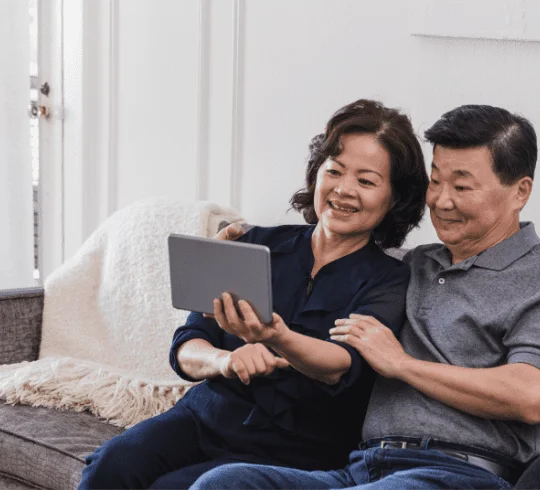 A senior couple looking at a tablet