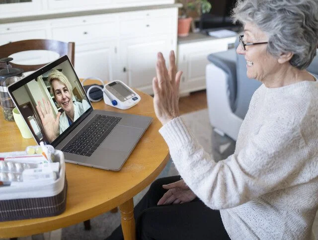 Senior woman having online consultation with her doctor in a video call