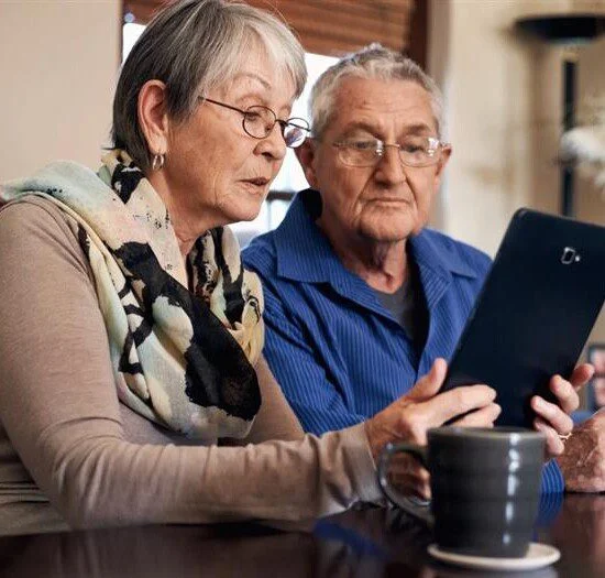 Senior couple learning about the costs of aging in place.