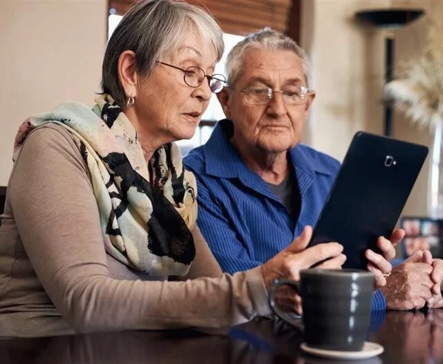 Senior couple learning about the costs of aging in place.