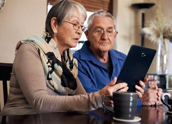 Senior couple learning about the costs of aging in place.