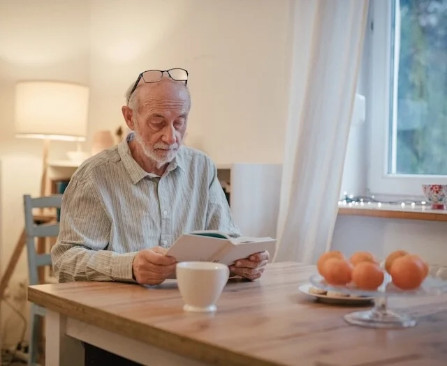 Older adult reading about senior living terminology