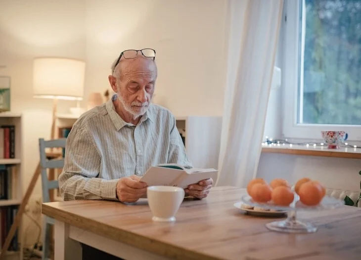 Older adult reading about senior living terminology