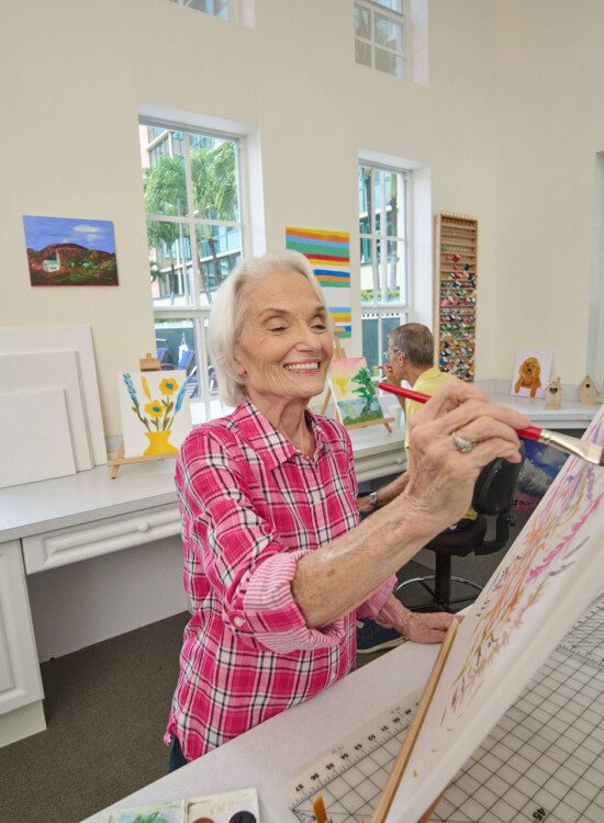 Senior women painting on a canvas