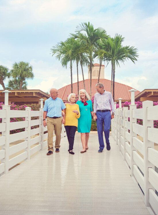 A group of seniors walking down a bridge together