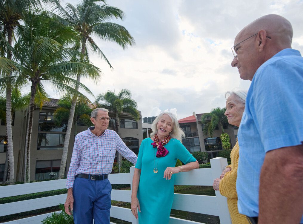 Group of seniors laughing on a bridge