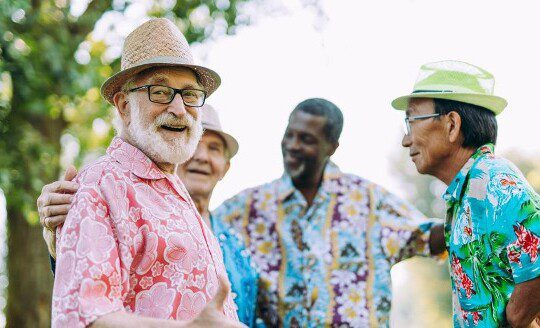 A group of seniors in Hawaiian shirts smiling