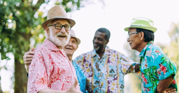 A group of seniors in Hawaiian shirts smiling