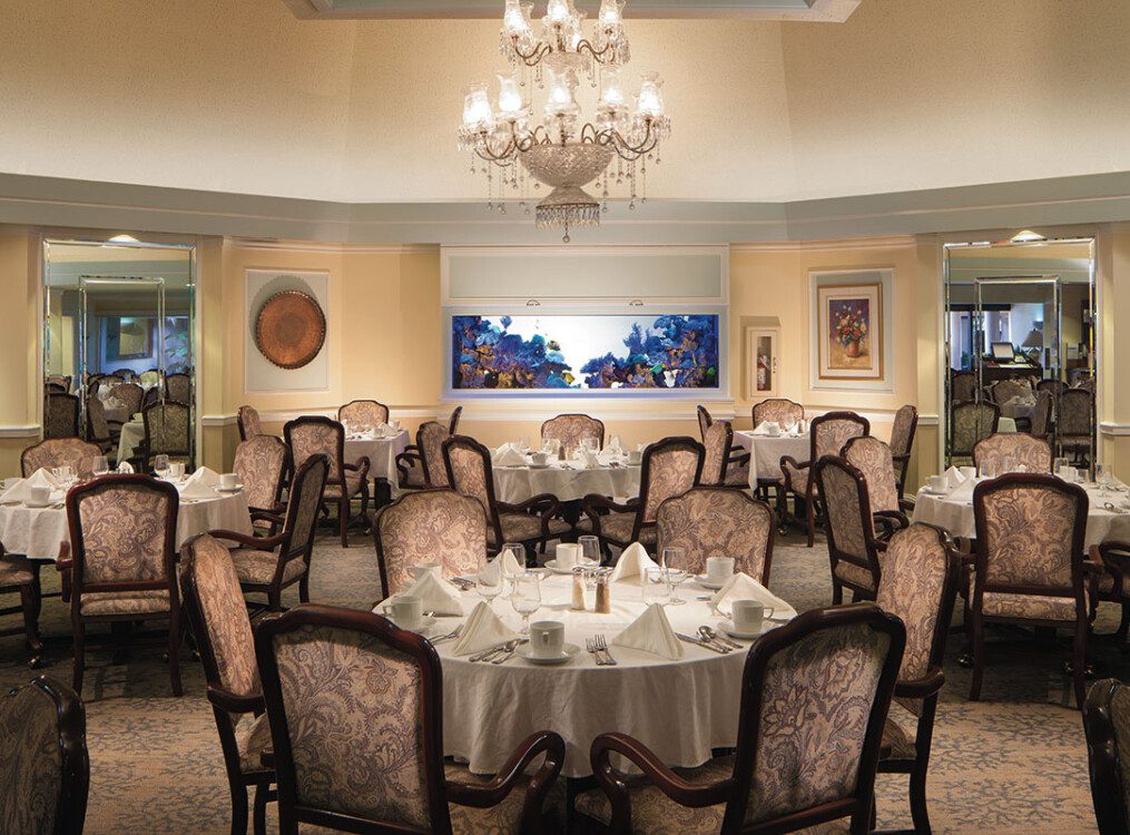 Fancy dining area with empty tables and a chandelier