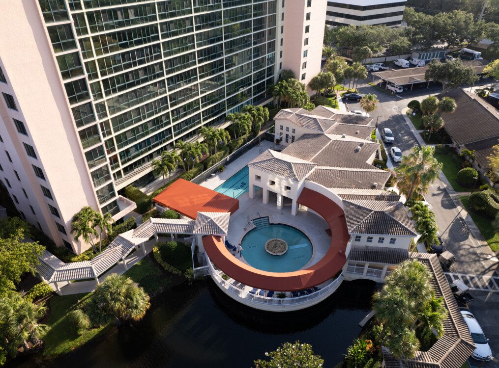 An aerial view of a a round pool and lounge area