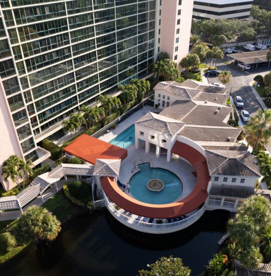 An aerial view of a a round pool and lounge area