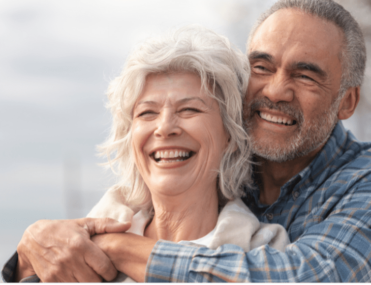 A senior couple hugging facing the same direction