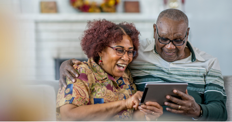 A senior couple looking at a tablet together