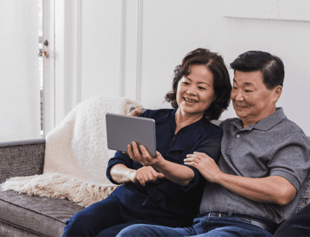 A senior couple looking at a tablet