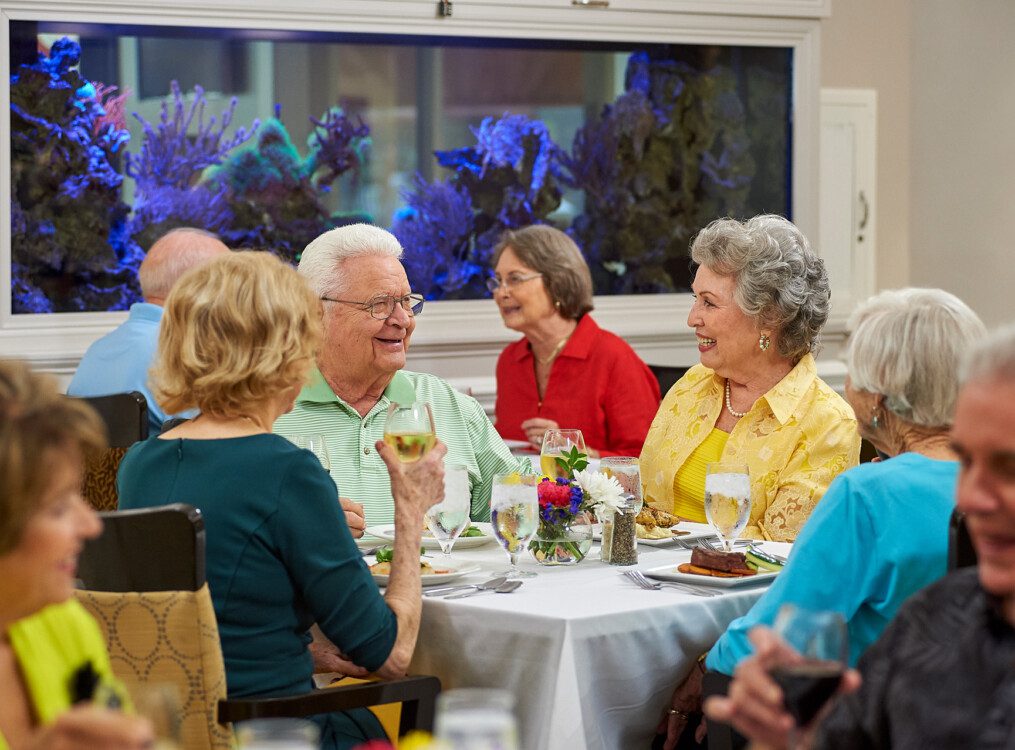 A group of seniors smiling while at dinner