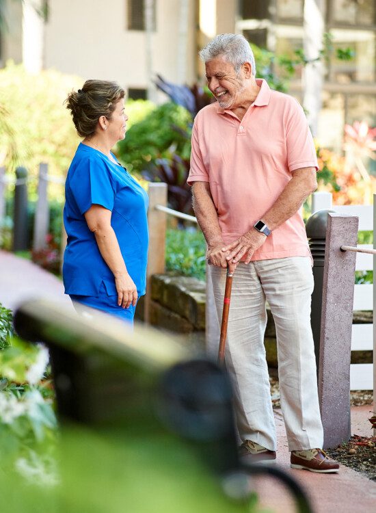 A senior man talking to a skilled nurse