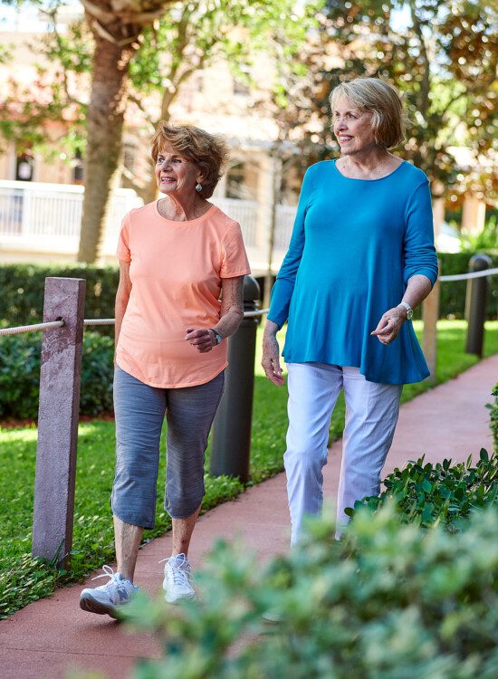 Two senior woman on a walk at their senior living facility