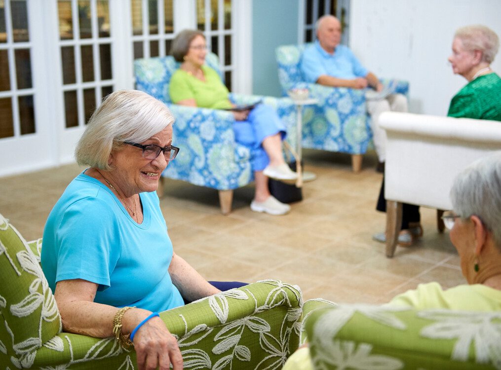 Two senior woman talking in lounge chairs