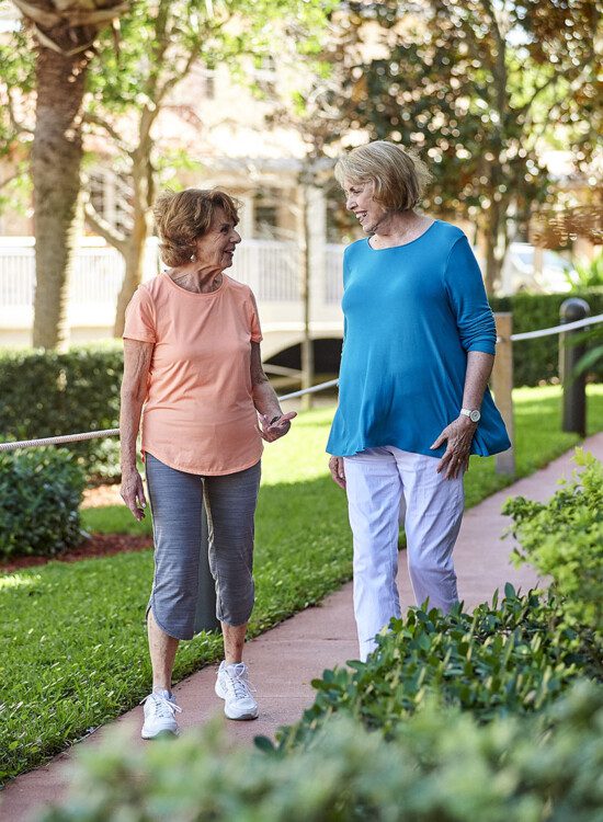 Two senior women talking while on a walk