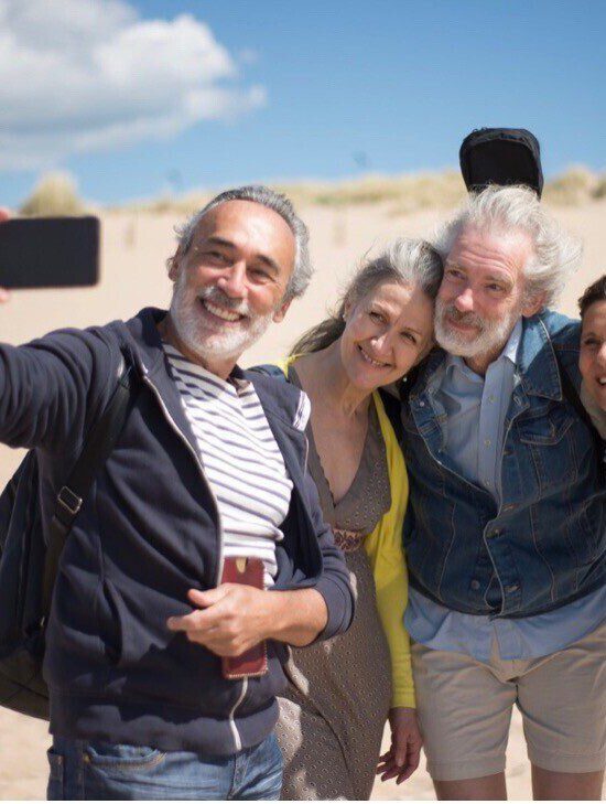 Four seniors taking a selfie on the beach