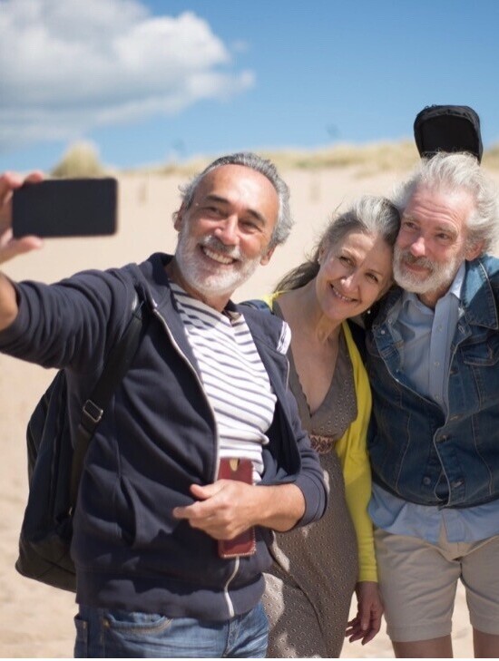Four seniors taking a selfie on the beach