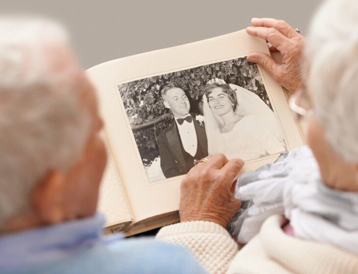 A senior couple looking at their wedding photos