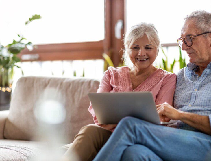 A senior couple looking at a laptop together