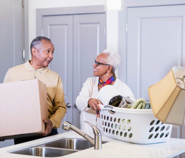 A senior couple moving into a Waterford senior living apartment