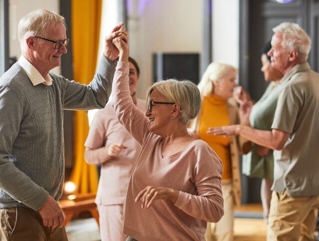Senior People Dancing in Retirement Home